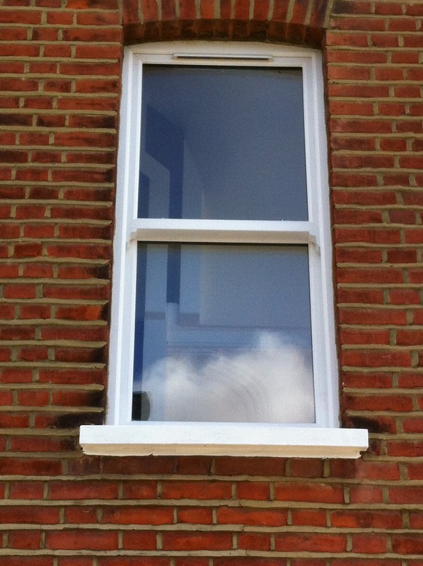 uPVC sash window on Victorian red brick house in Pimlico